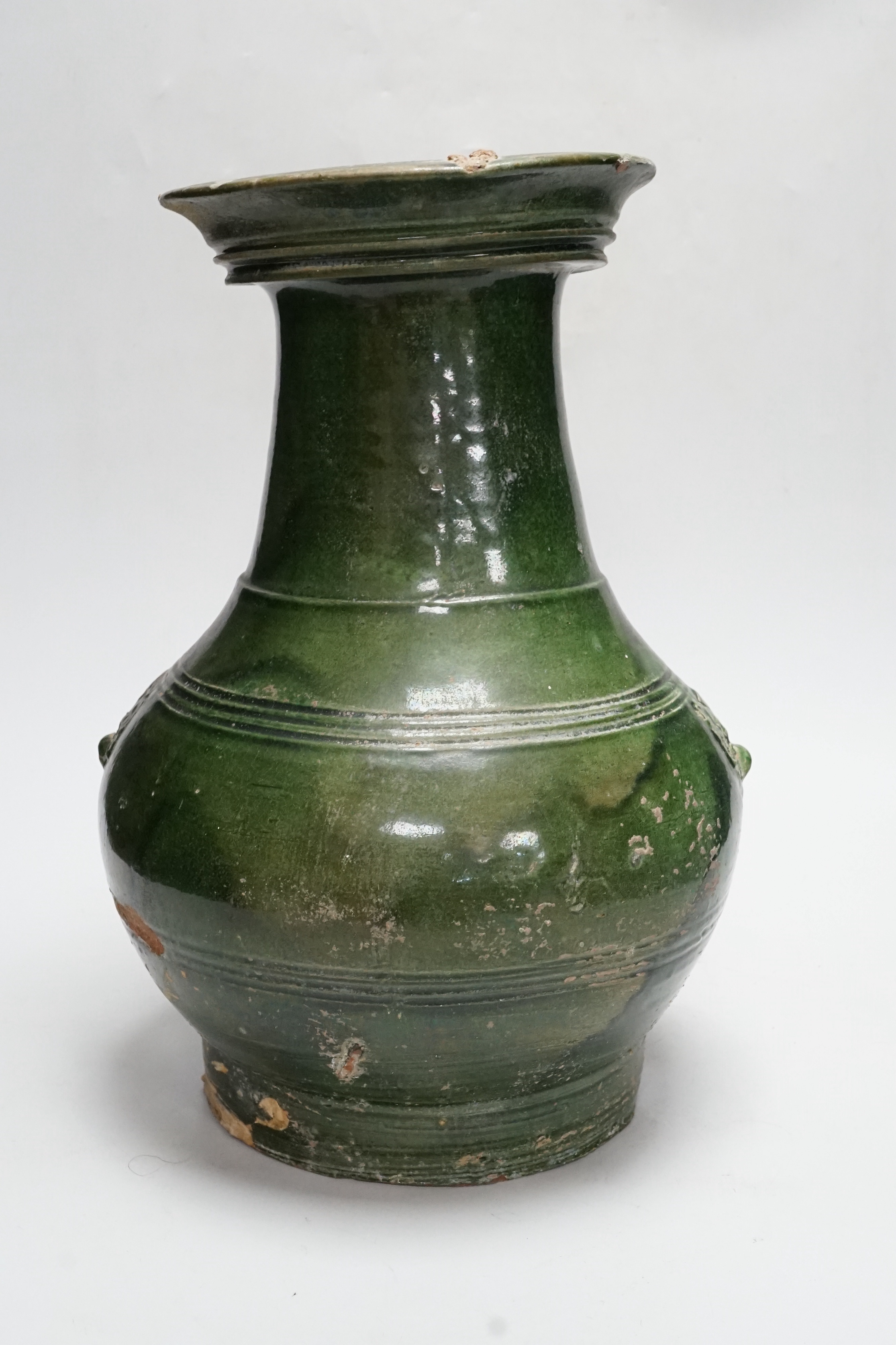 A Chinese Han dynasty dark green glazed ribbed baluster vase, hu, 34cm